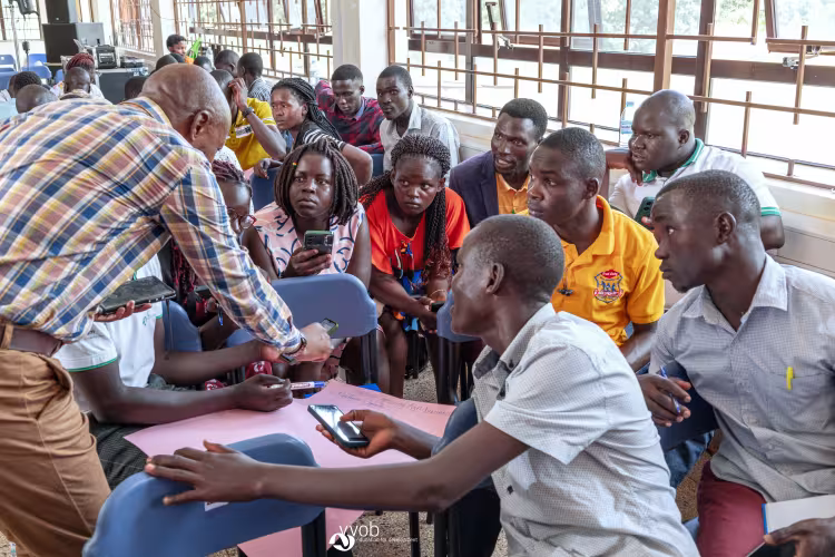 Facilitator interacts with university students during a group discussion activity