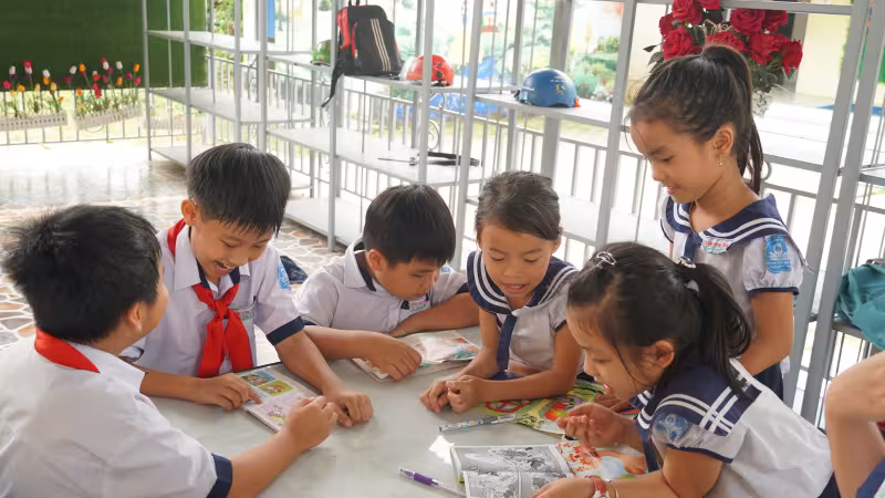Children play around a table in Vietnam