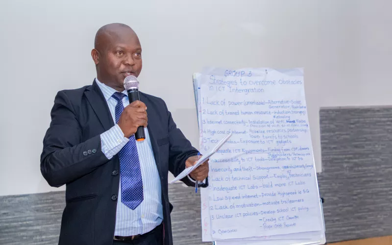 Stephen, a school leader in Kenya, stands with a mic in hand