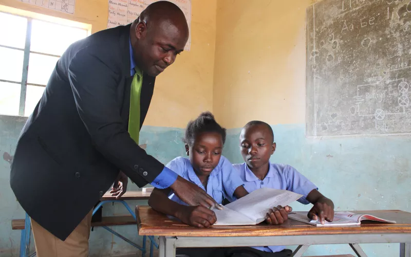Teacher explaining to two learners during a Catch Up lesson
