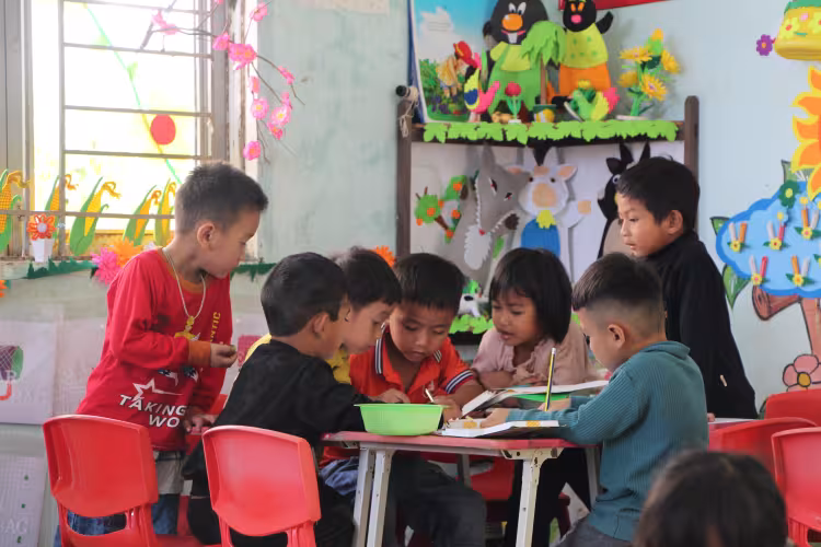 Children doing group work in the classroom.