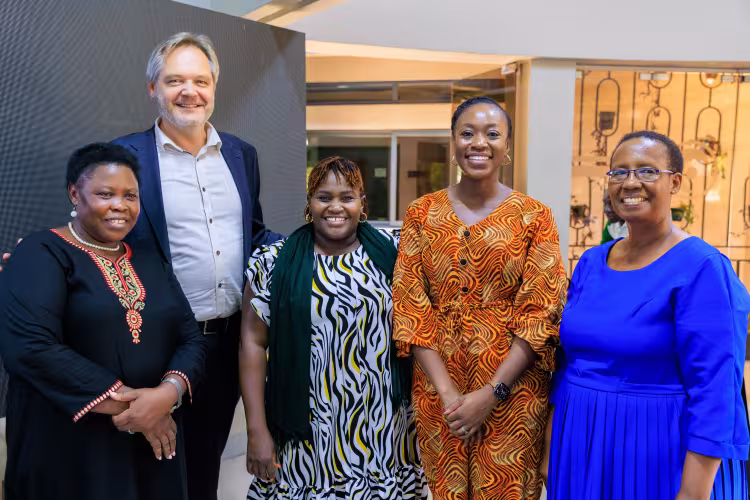 Group photo of five people smiling.