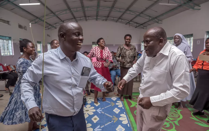 Teachers playfully interact during a training