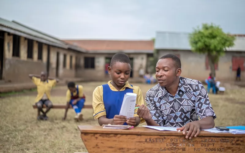 A teacher assesses a learner in Uganda