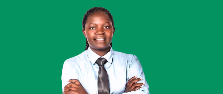 Image of teacher Victoria facing the camera with a green background behind her