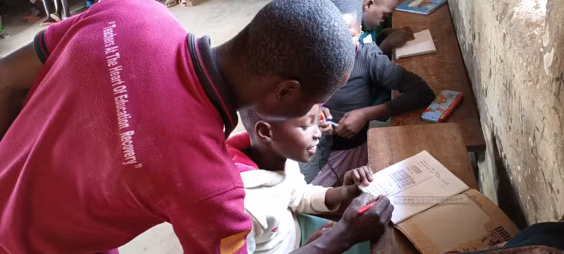 Shem, a Coordinating Centre Tutor is tutoring a young learner.