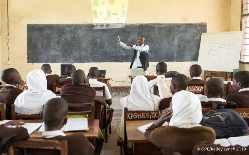 Teacher in Tanzania teaching a class.
