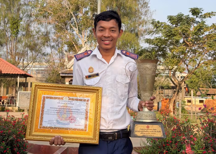 Teacher Oh Kainha pictured with his awards