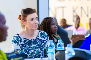 Women sitting in audience at an event.