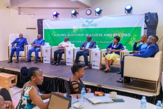 A panel discussion featuring six panelists and a moderator.