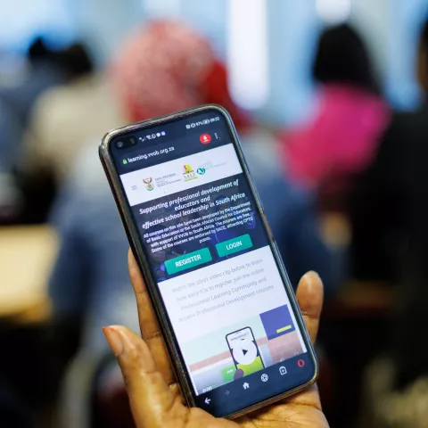 A hand holding a phone.