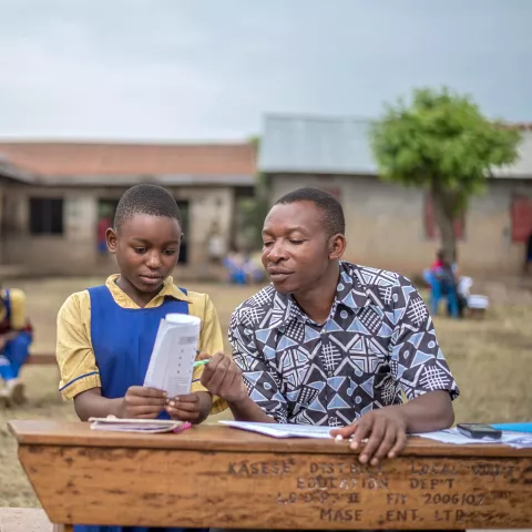 A teacher assesses a learner in Uganda