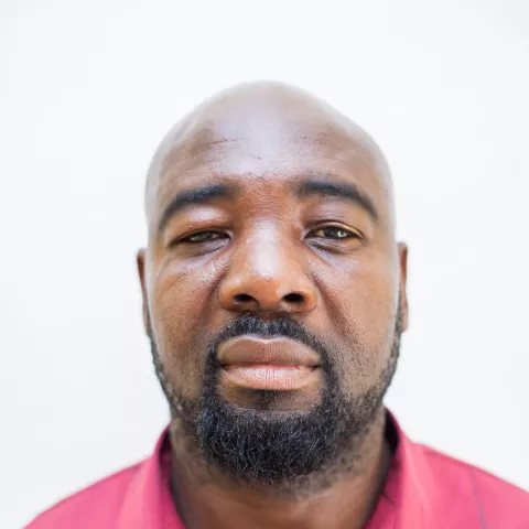 Sebby is wearing a red shirt. The background is plain white.